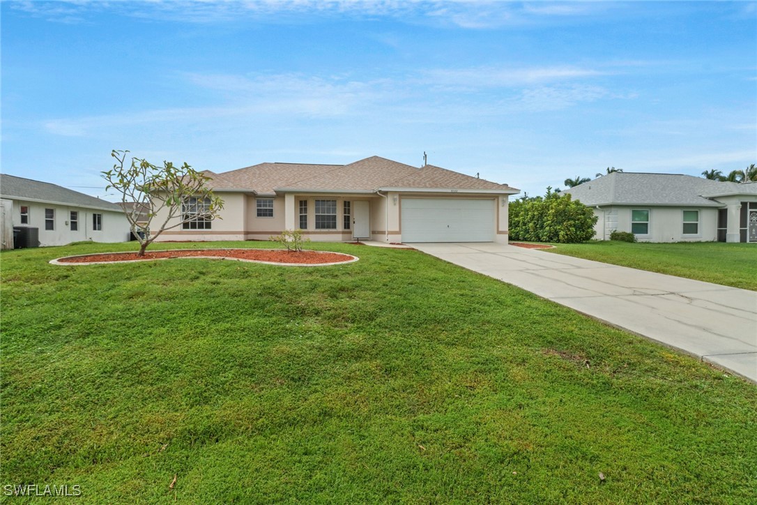 a front view of a house with a garden and yard