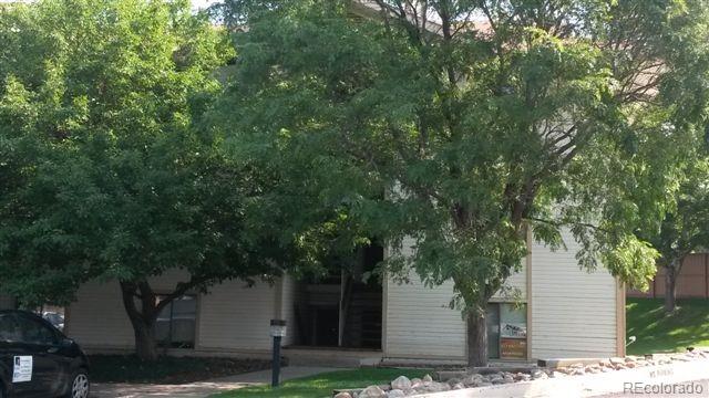 a front view of a house with a tree