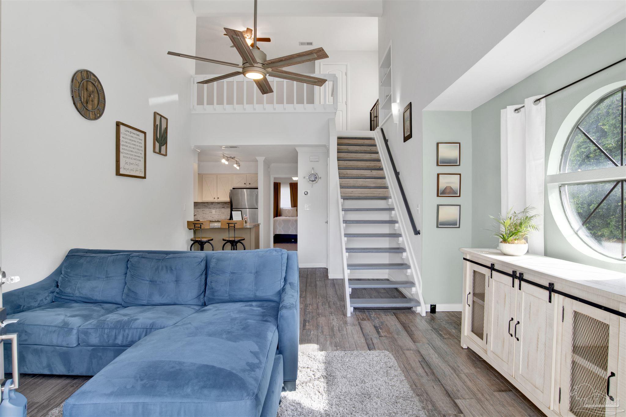 a living room with furniture and wooden floor