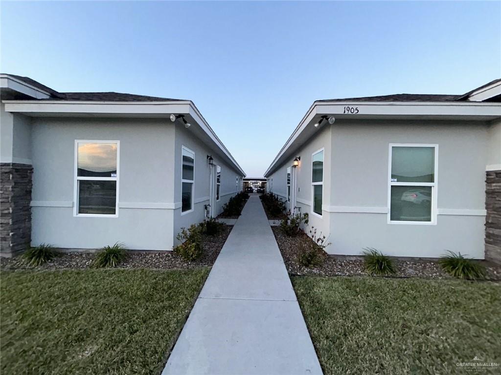 View of side of property featuring a lawn