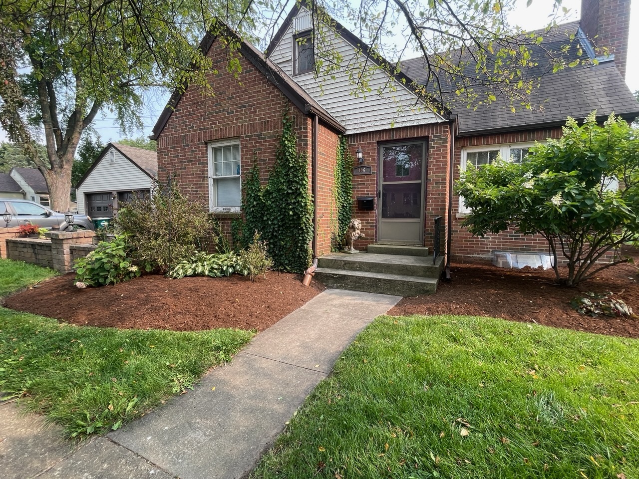 a front view of a house with a garden