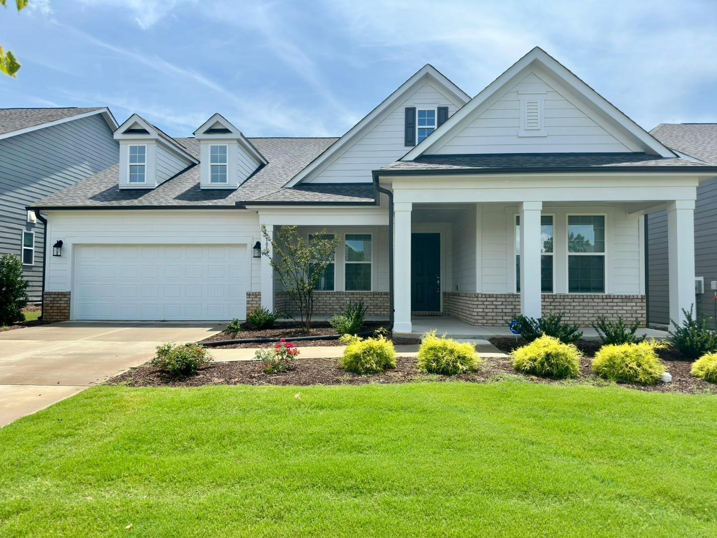 front view of a house with an yard