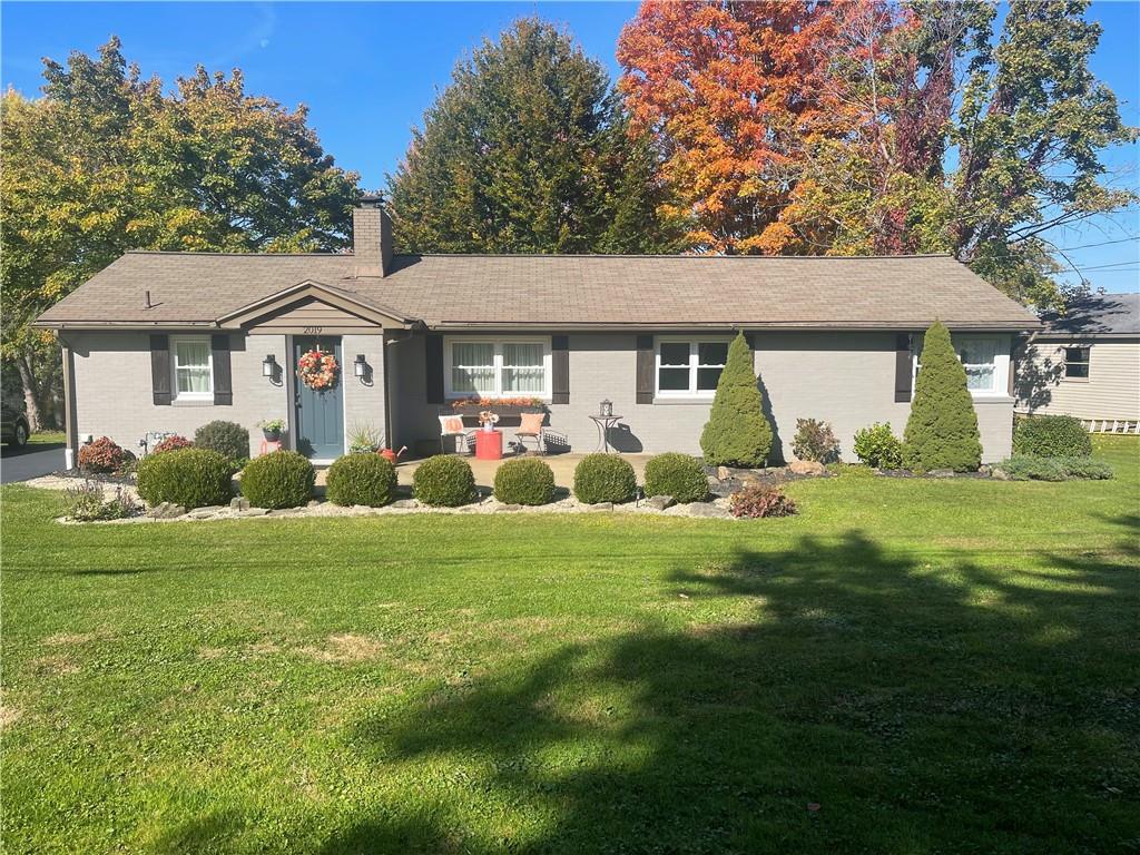 a front view of house with yard and green space