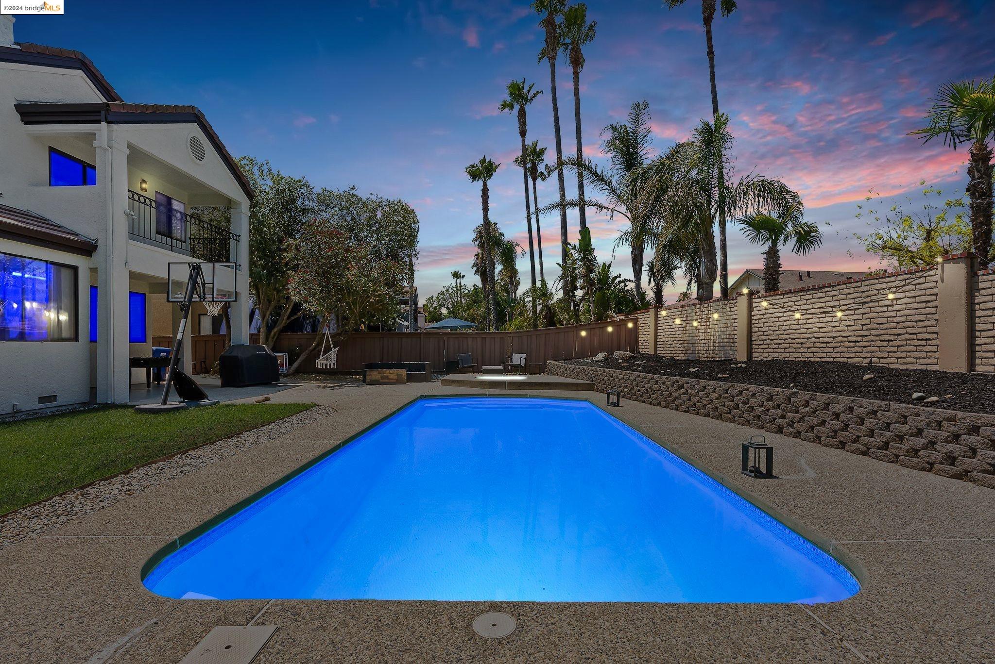 a view of swimming pool with outdoor seating and yard