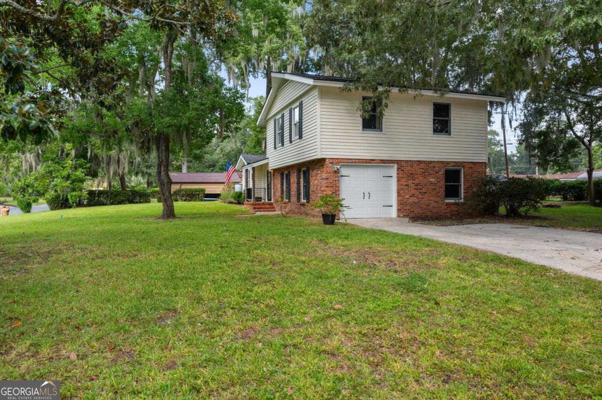 a front view of house with yard and green space