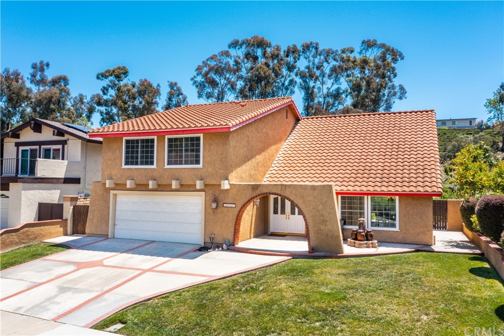 a front view of a house with a yard and a garage