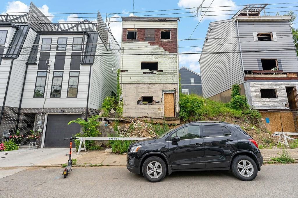 front view of a house with car parked