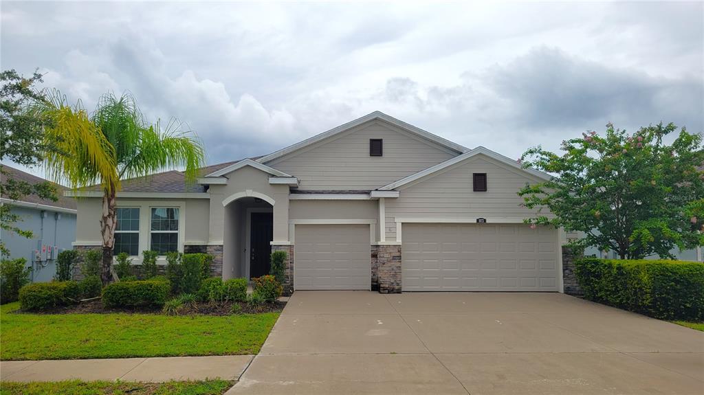 a front view of a house with a yard and garage