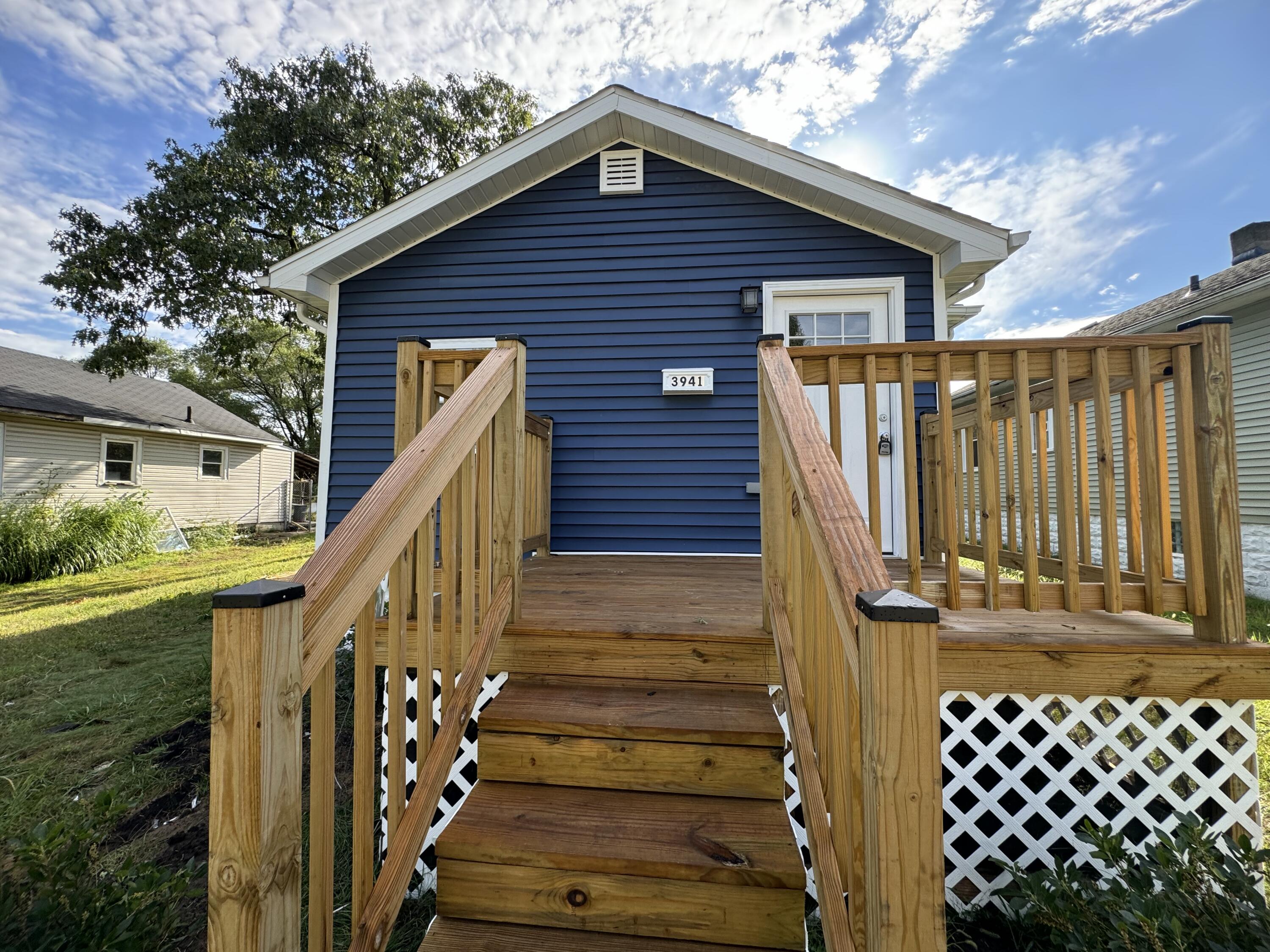 a view of wooden house with wooden fence