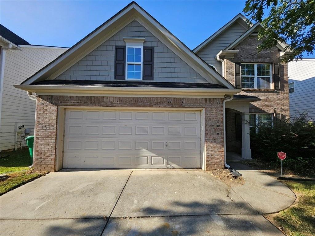 a front view of a house with garage