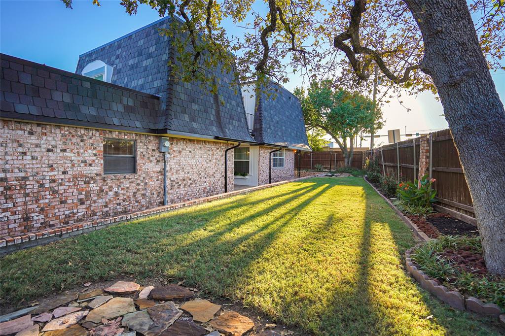 Back of house with a patio area and a yard