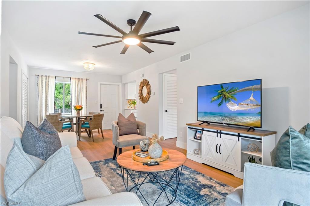 a living room with furniture a rug and a large window