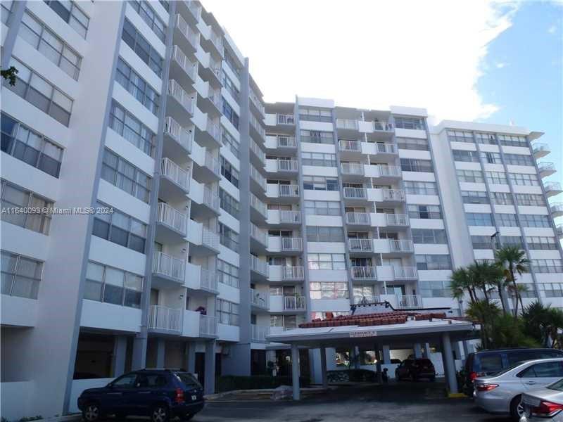 a view of a building with a lot of cars parked