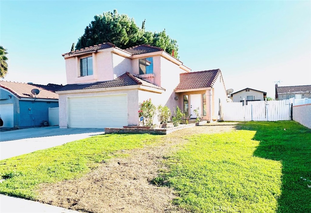 a view of a house with a yard and garage