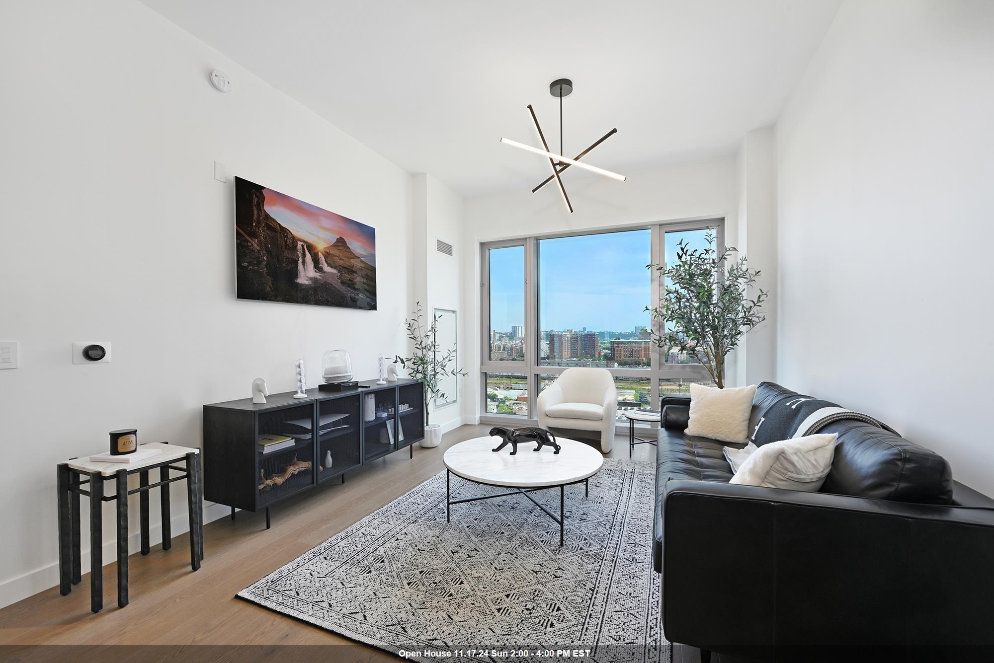 a living room with furniture a rug and a flat screen tv