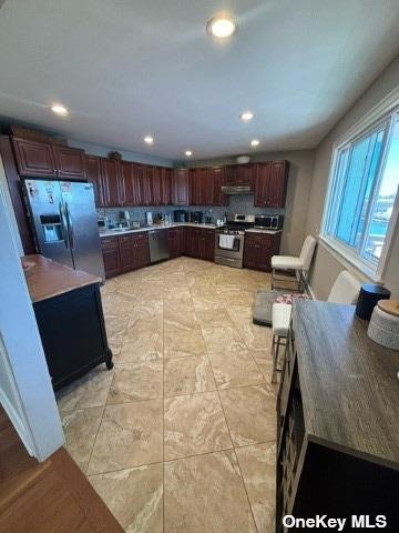 a view of kitchen with kitchen island dining table and chairs