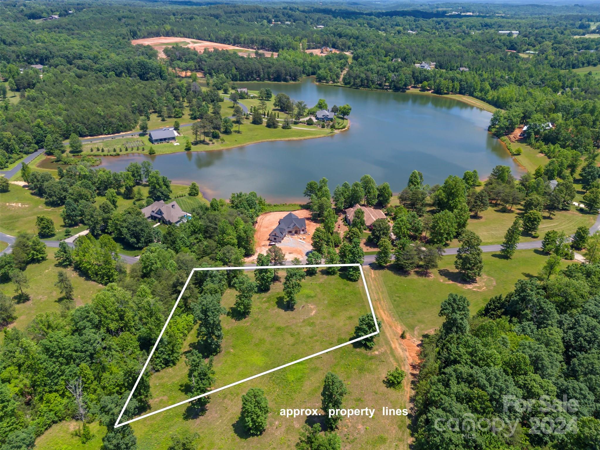 an aerial view of a house with a lake view