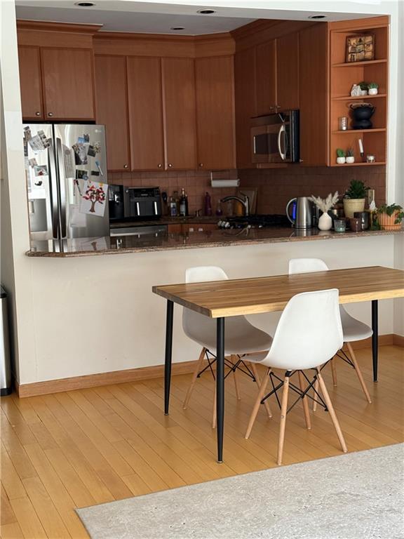 a room with wooden cabinets a table and chairs