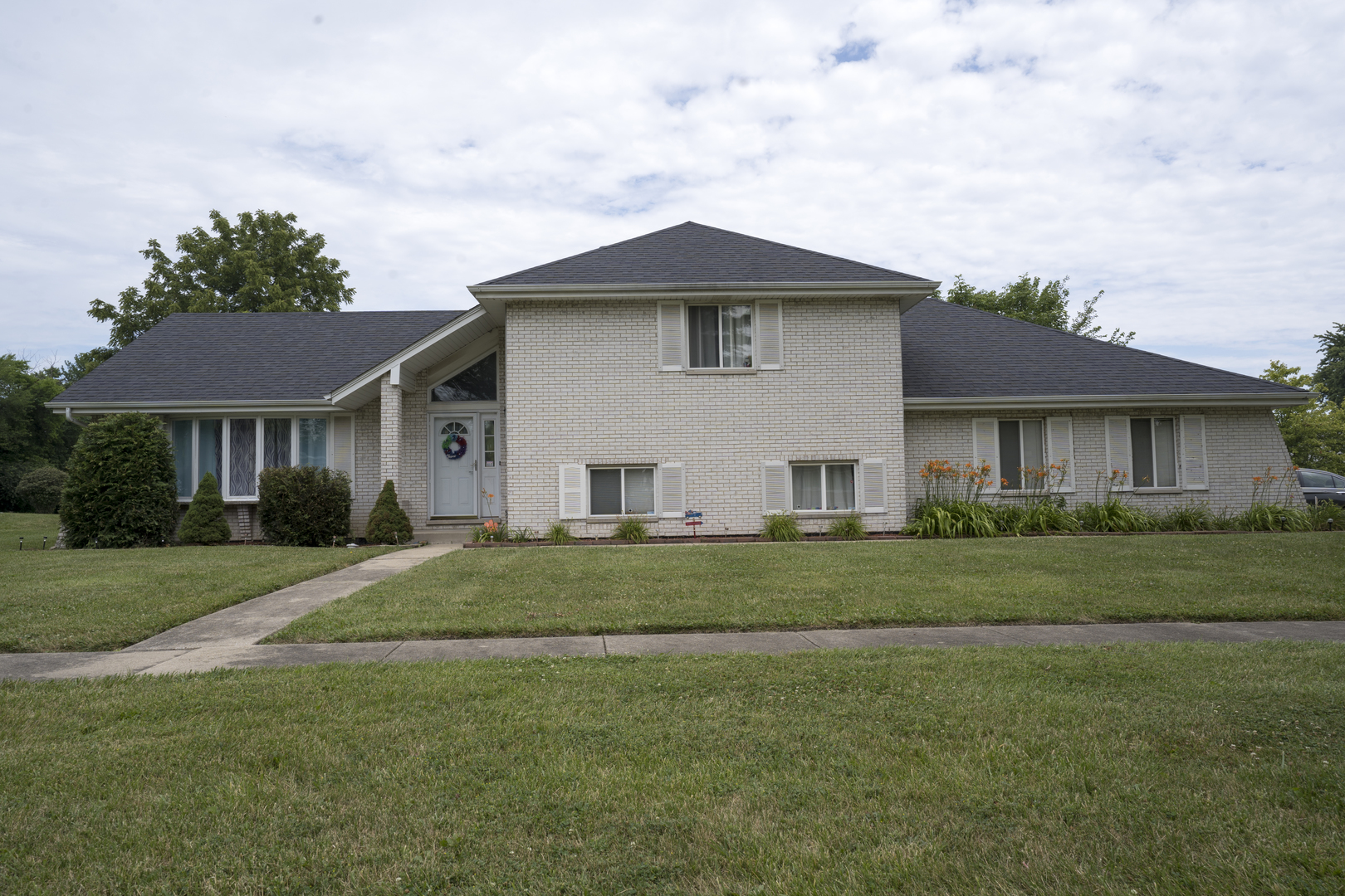 a front view of a house with a yard