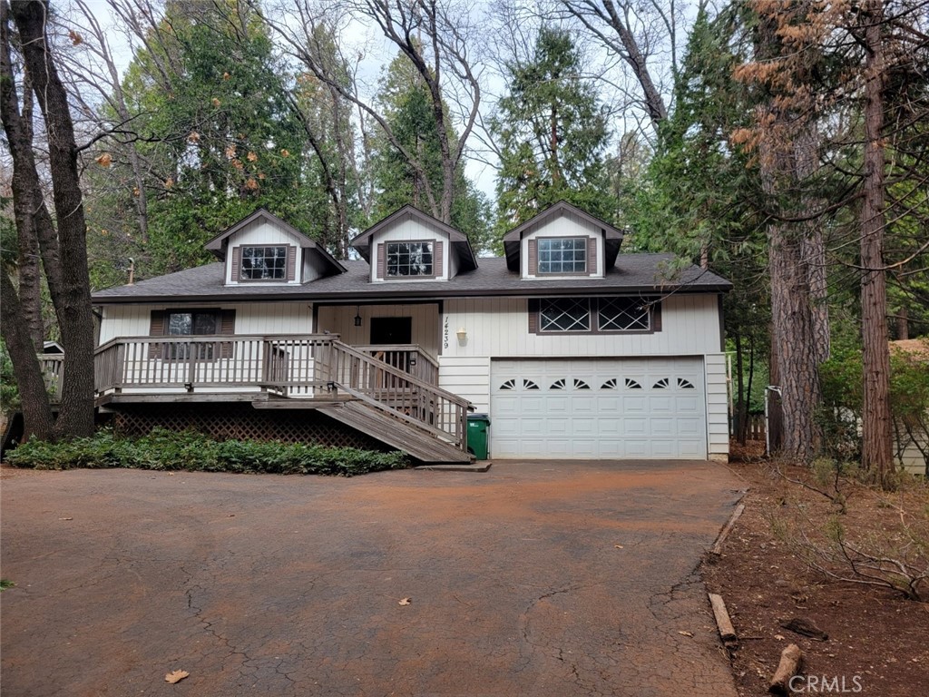 a view of house with outdoor space and deck