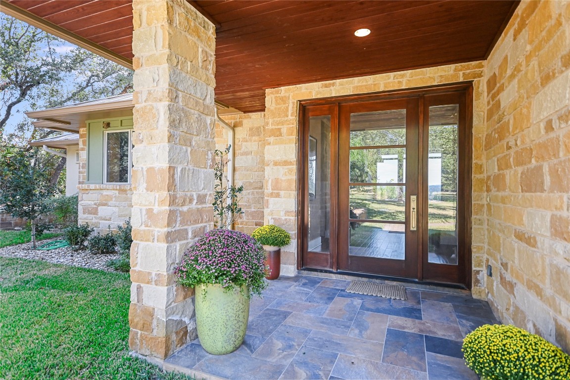 a view of a porch with potted plants