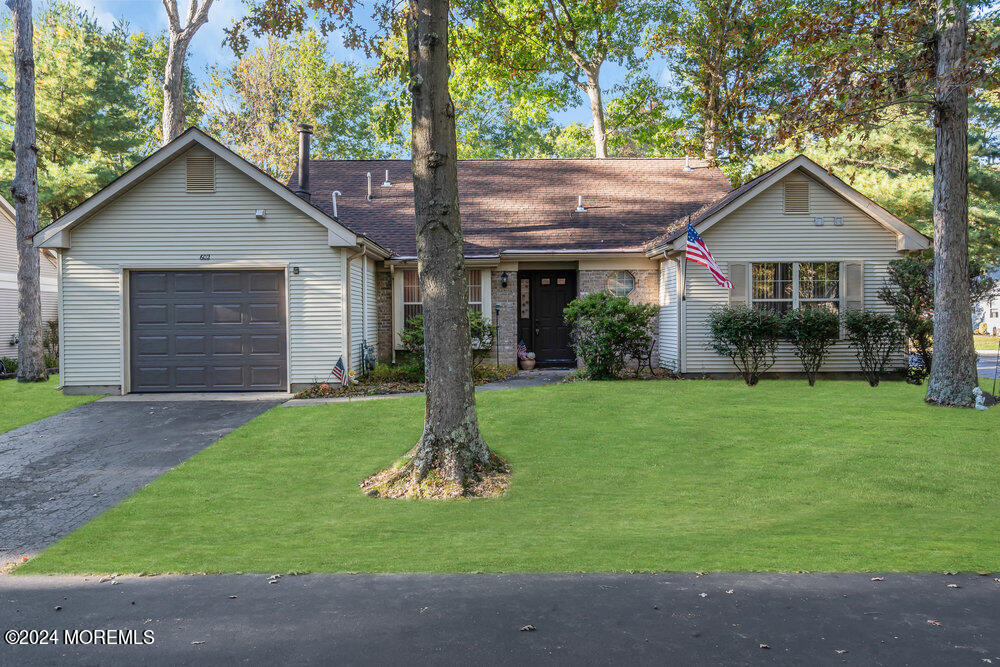 a front view of house with a garden