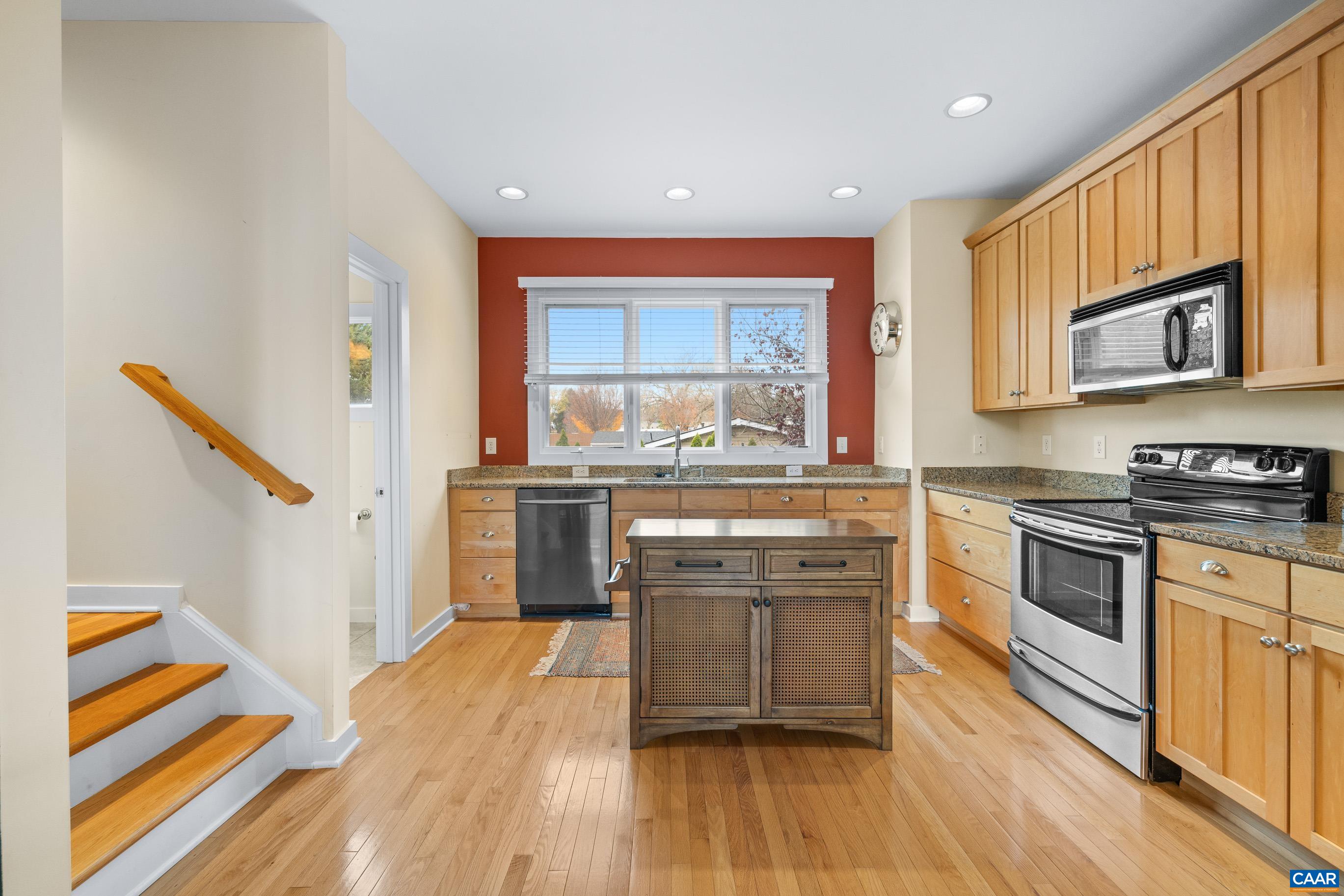 a kitchen with stainless steel appliances granite countertop a stove and a sink