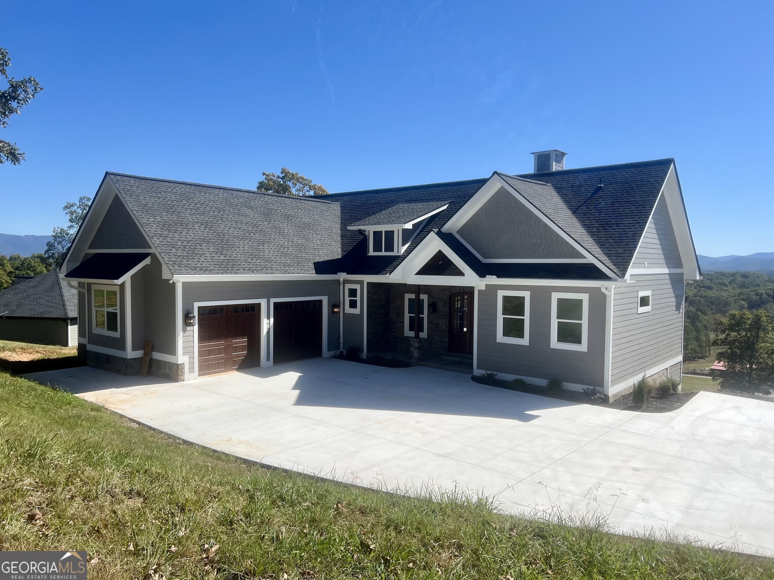 a front view of a house with a yard and garage