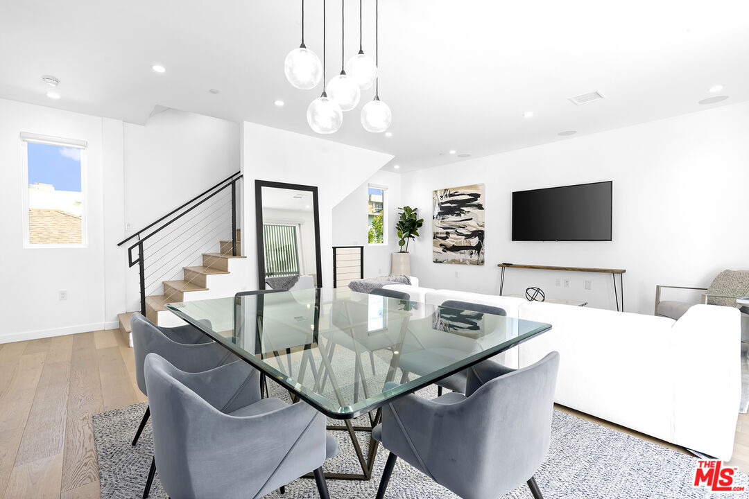 a view of a dining room with furniture and wooden floor