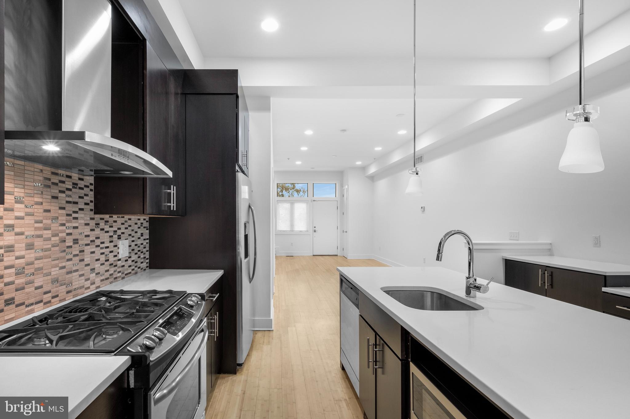 a kitchen with a sink stove and refrigerator