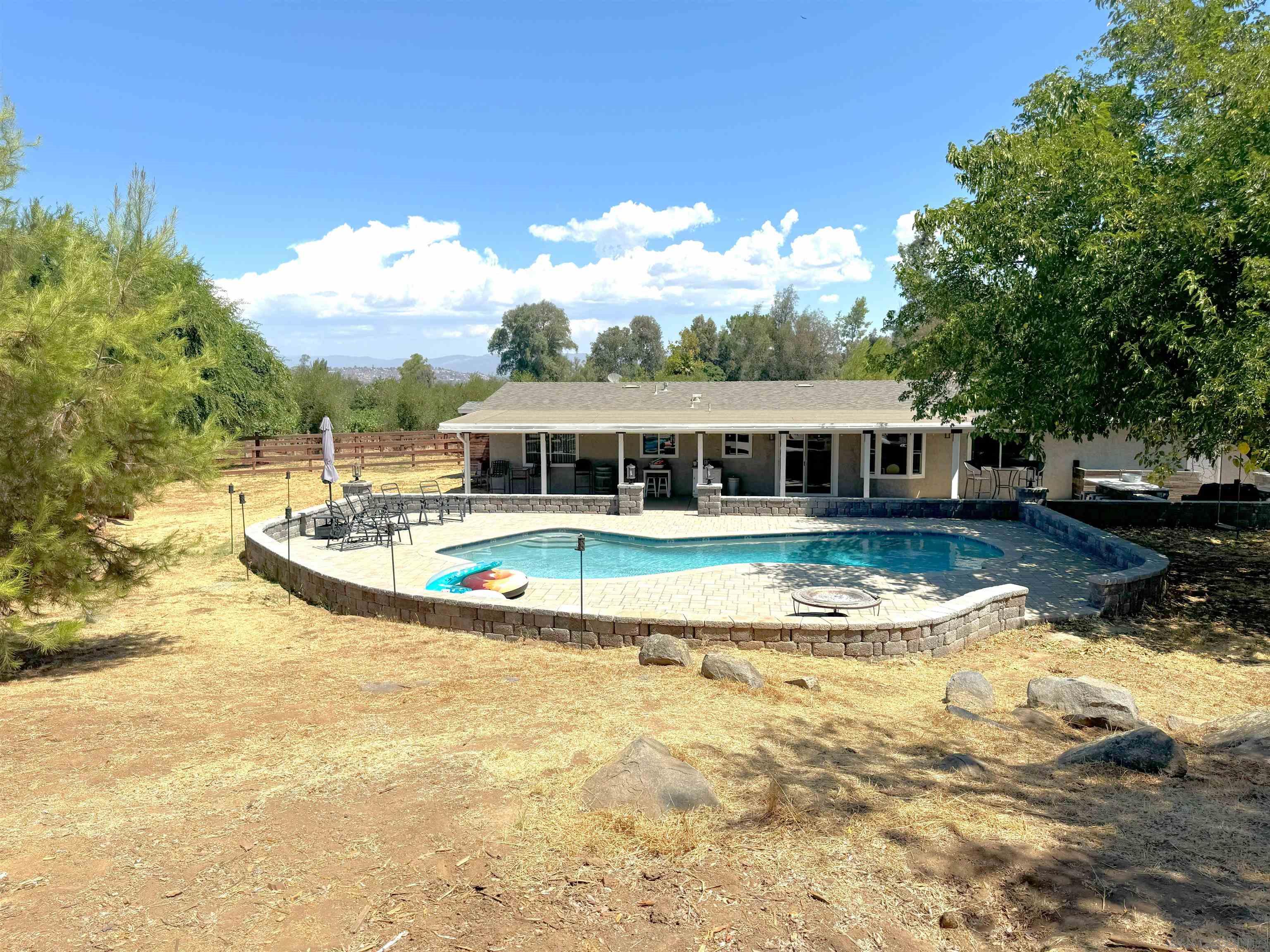 a view of a swimming pool with an outdoor seating