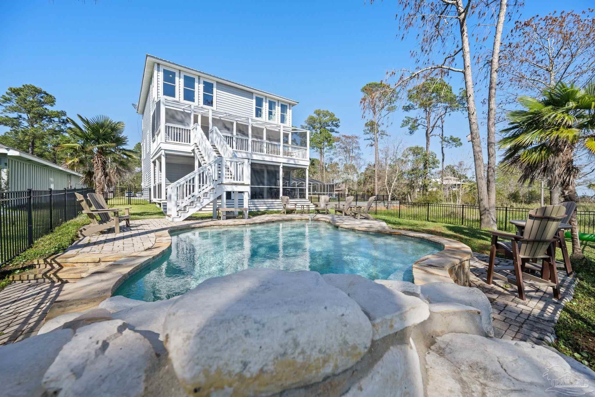 a view of swimming pool with outdoor seating