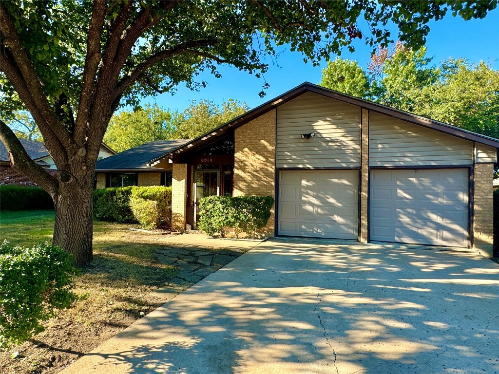 a view of a house with a tree in a yard