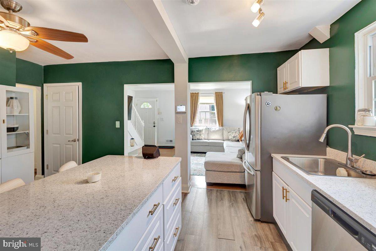 a kitchen with stainless steel appliances a refrigerator sink and cabinets