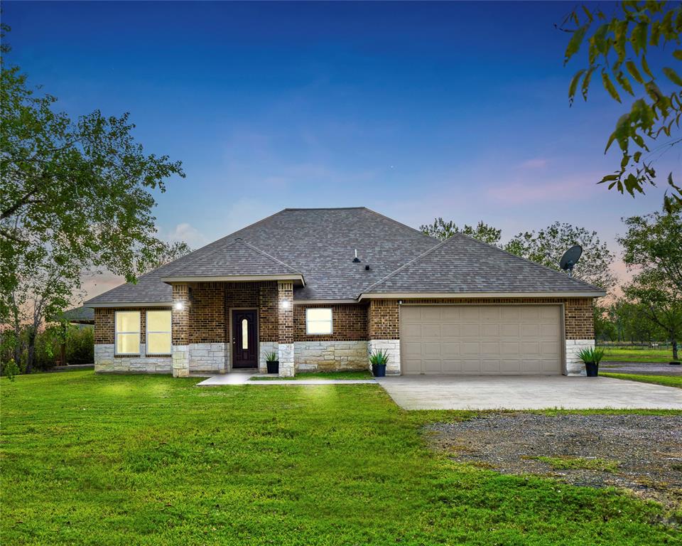 a front view of house with yard and outdoor seating