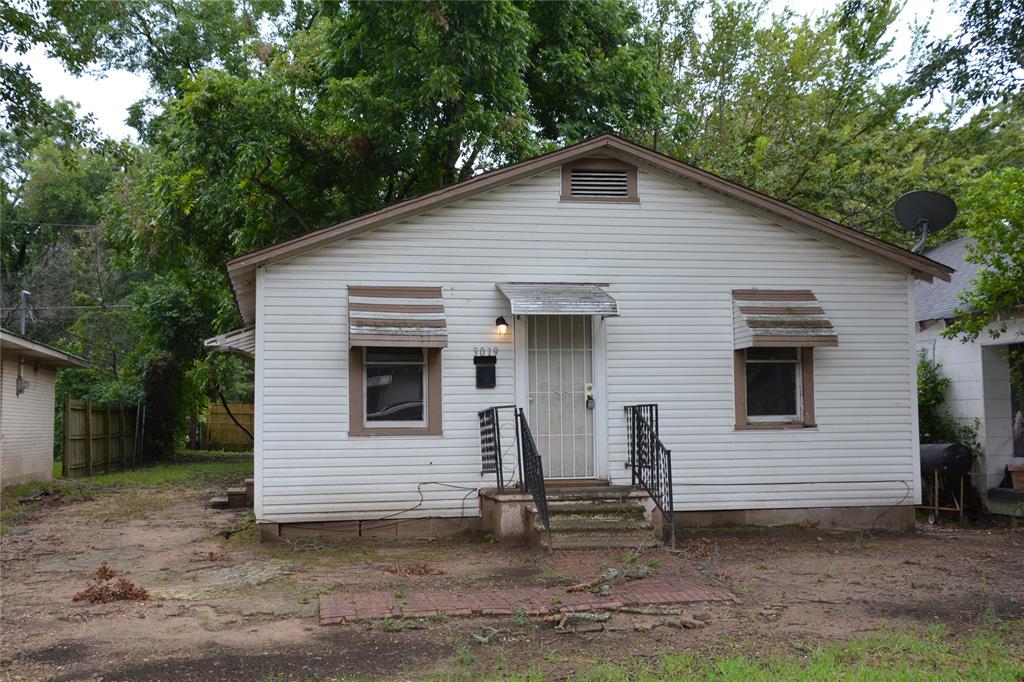 a view of a house with a yard chairs and garage