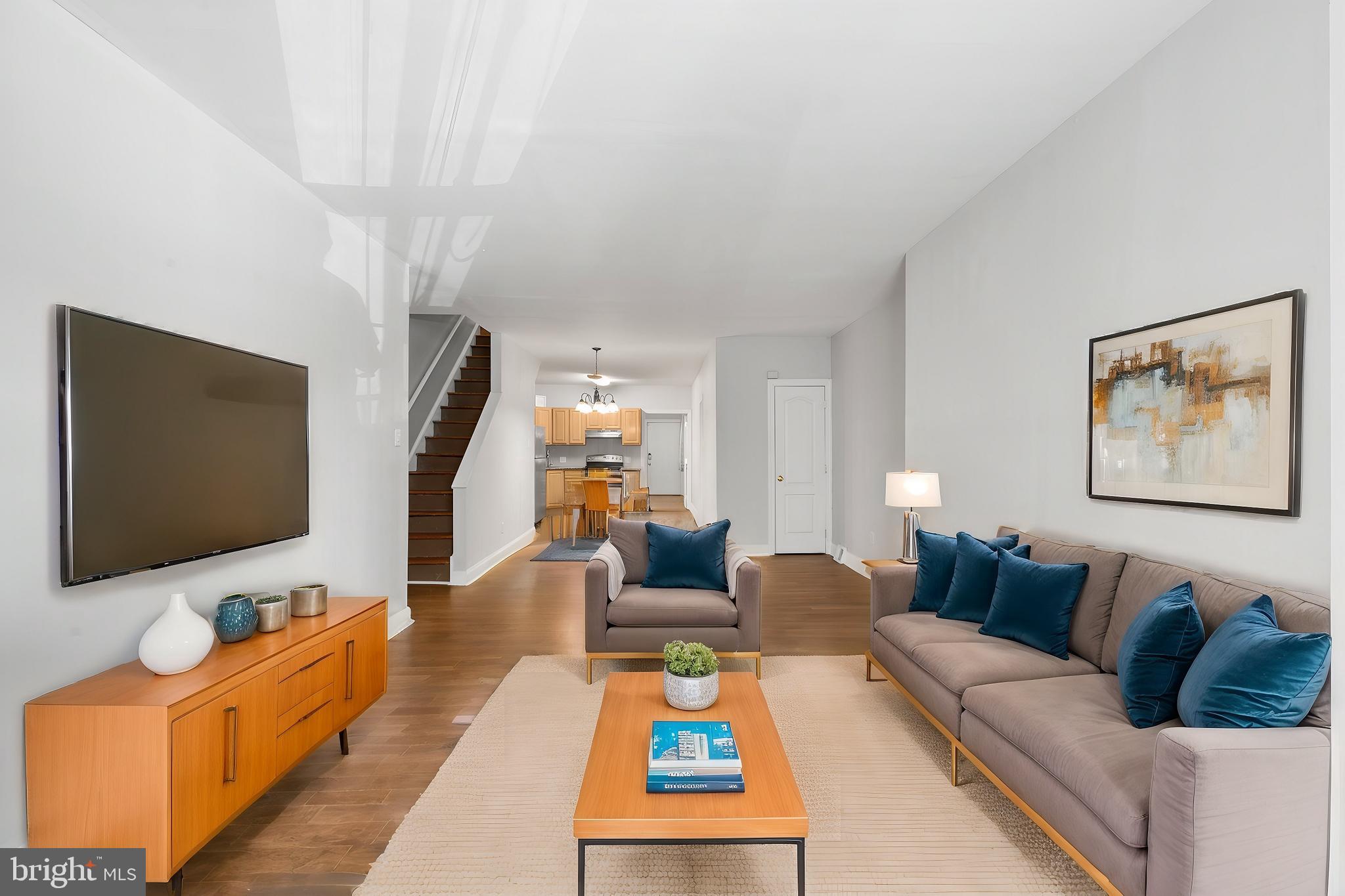 a living room with furniture and a flat screen tv