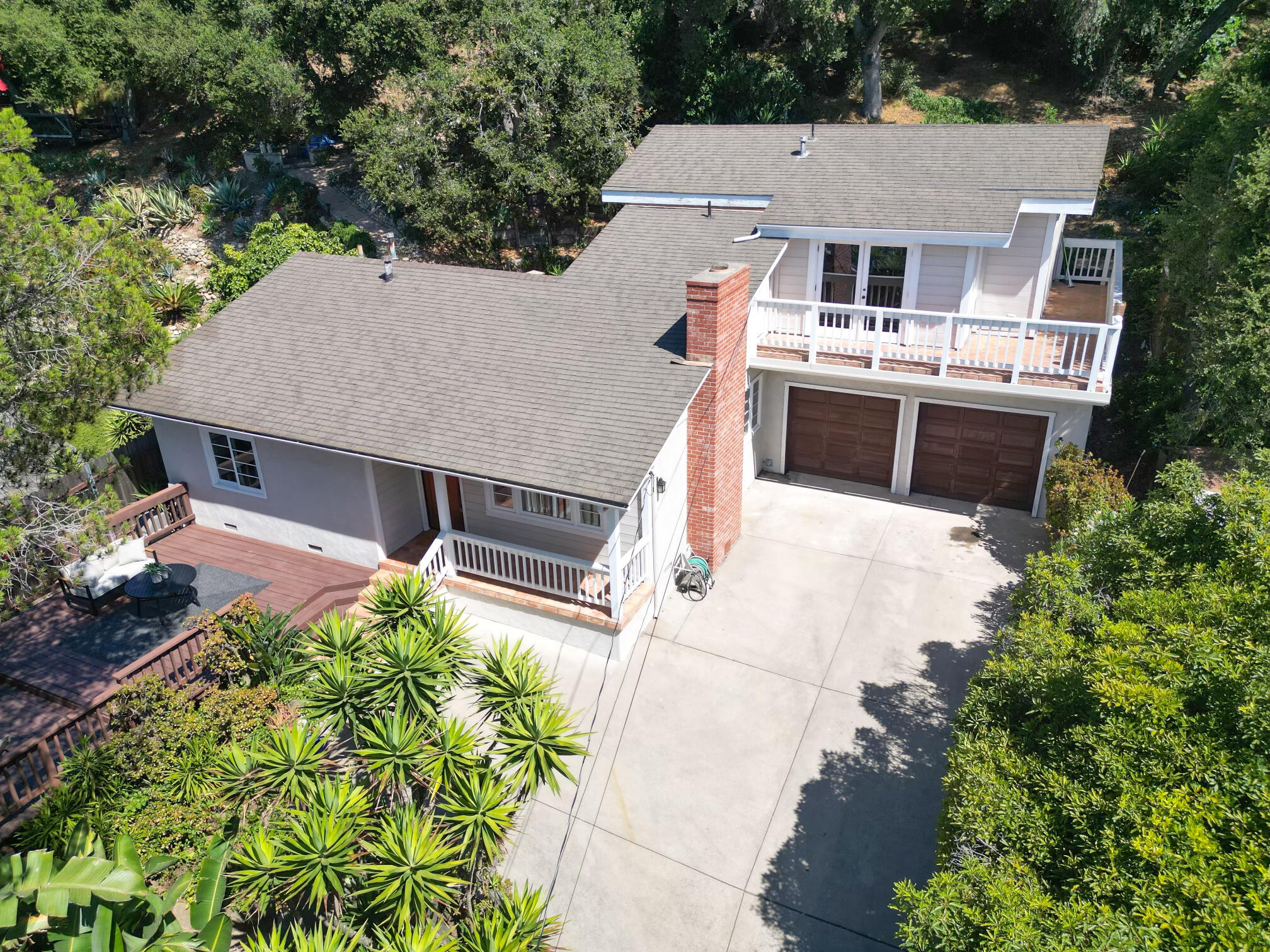 an aerial view of a house with a yard and potted plants