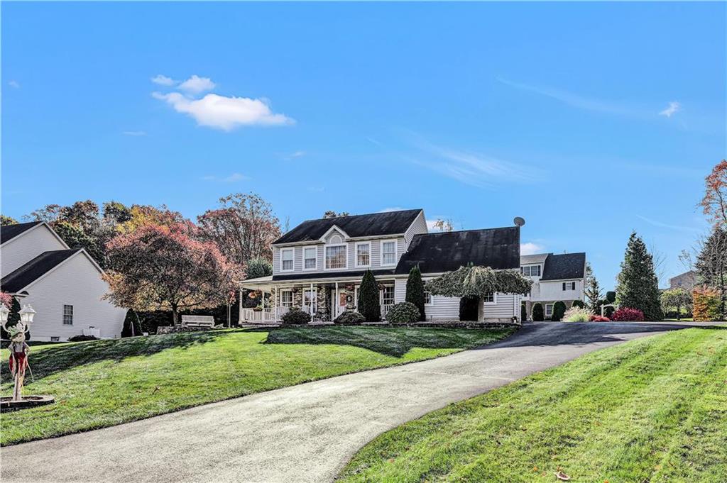 a front view of house with yard and green space