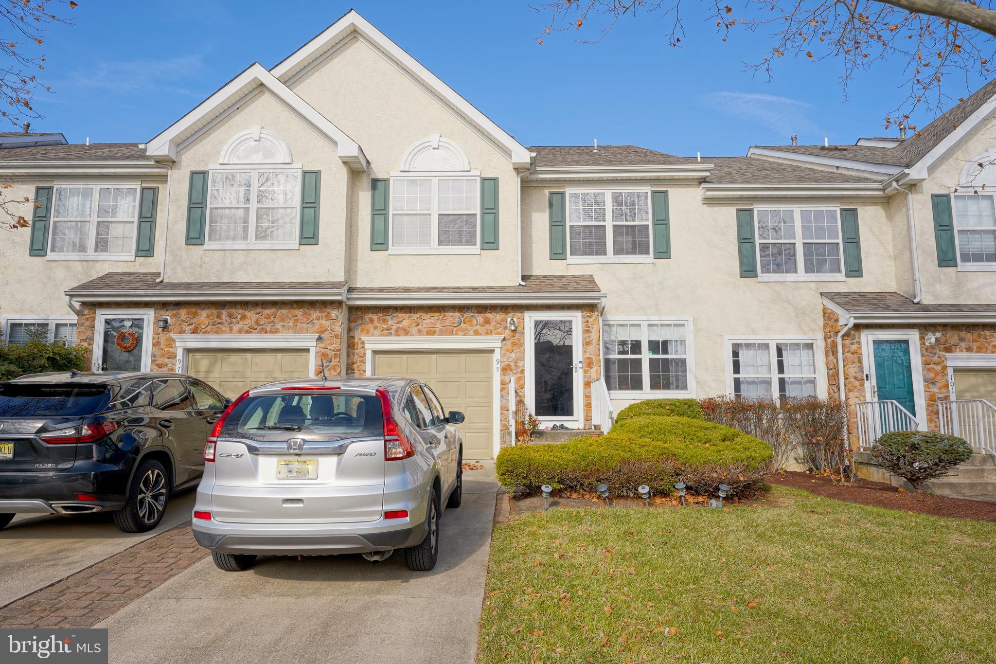 a front view of a house with a garden and barbeque oven