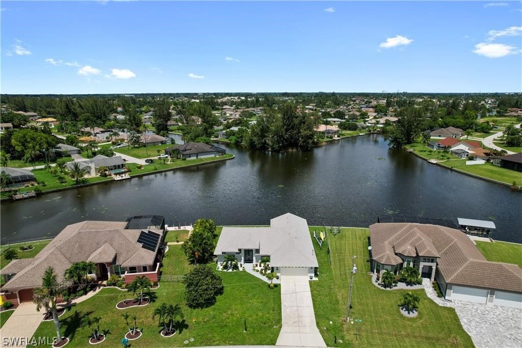 an aerial view of a house with a lake view