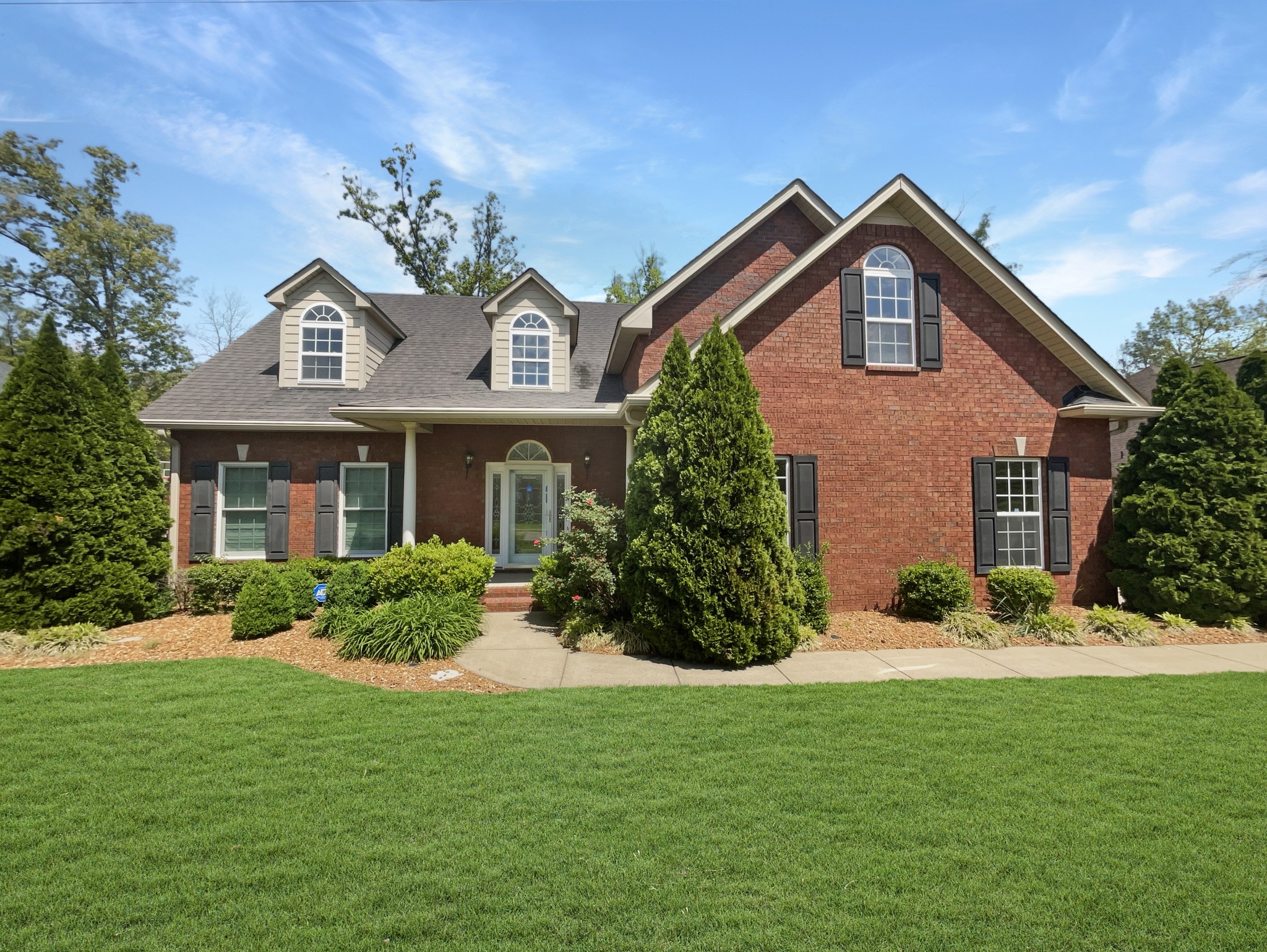 a front view of a house with a yard