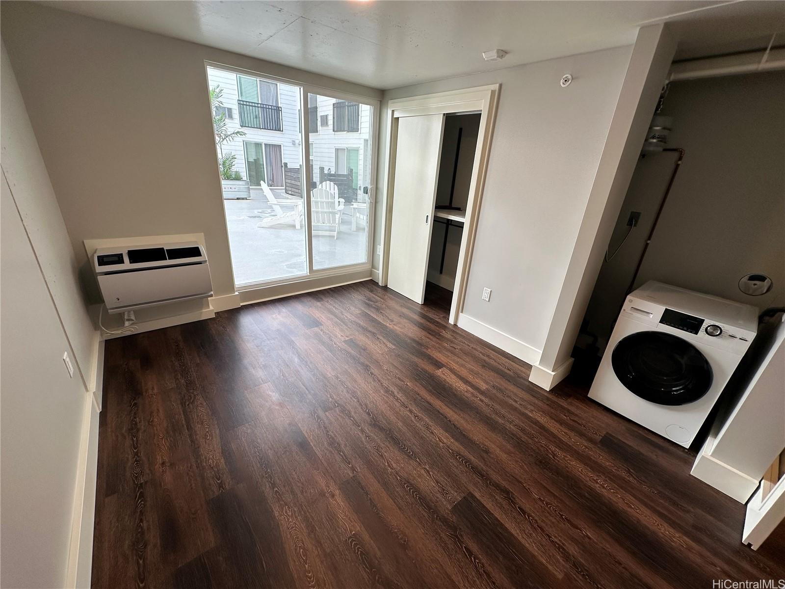 a view of a kitchen with wooden floor and cabinets