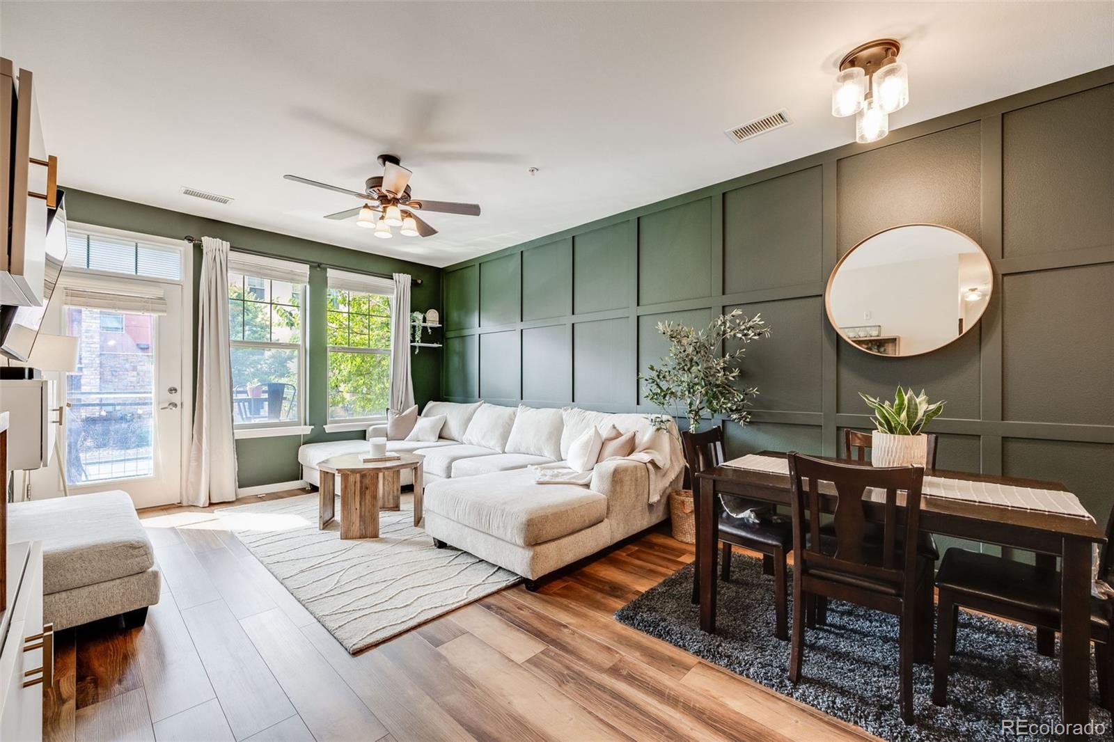 a living room with furniture a chandelier and a large window