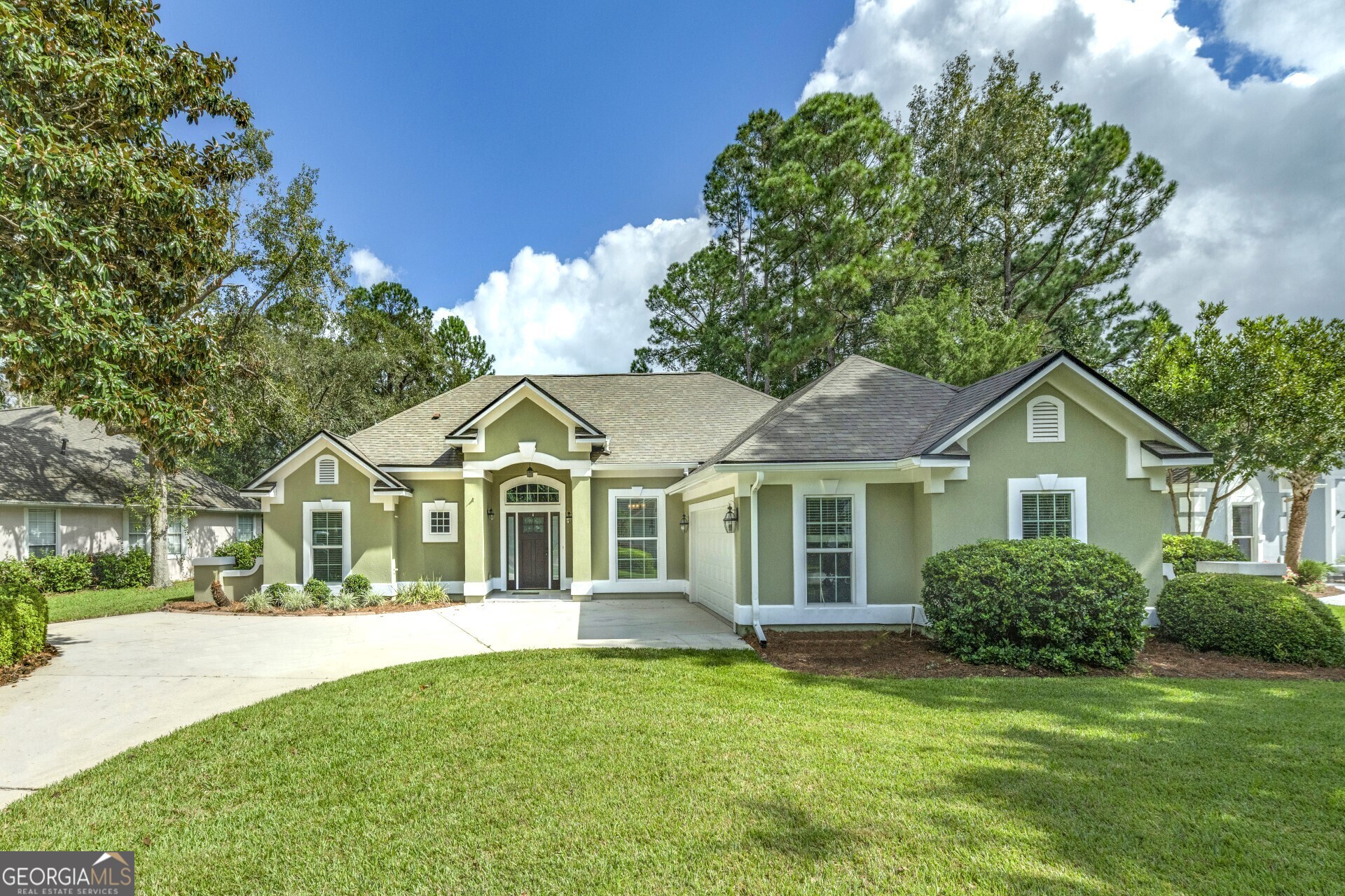 a front view of a house with a garden