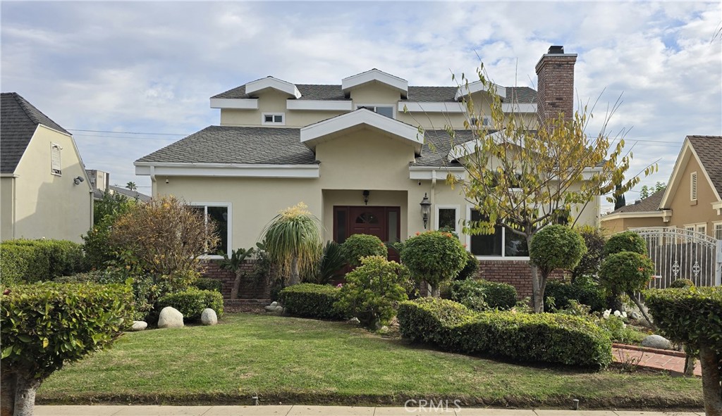 a front view of house with yard and green space