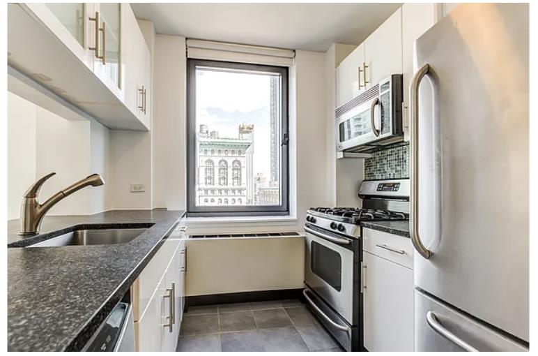 a kitchen that has a sink a stove and a window