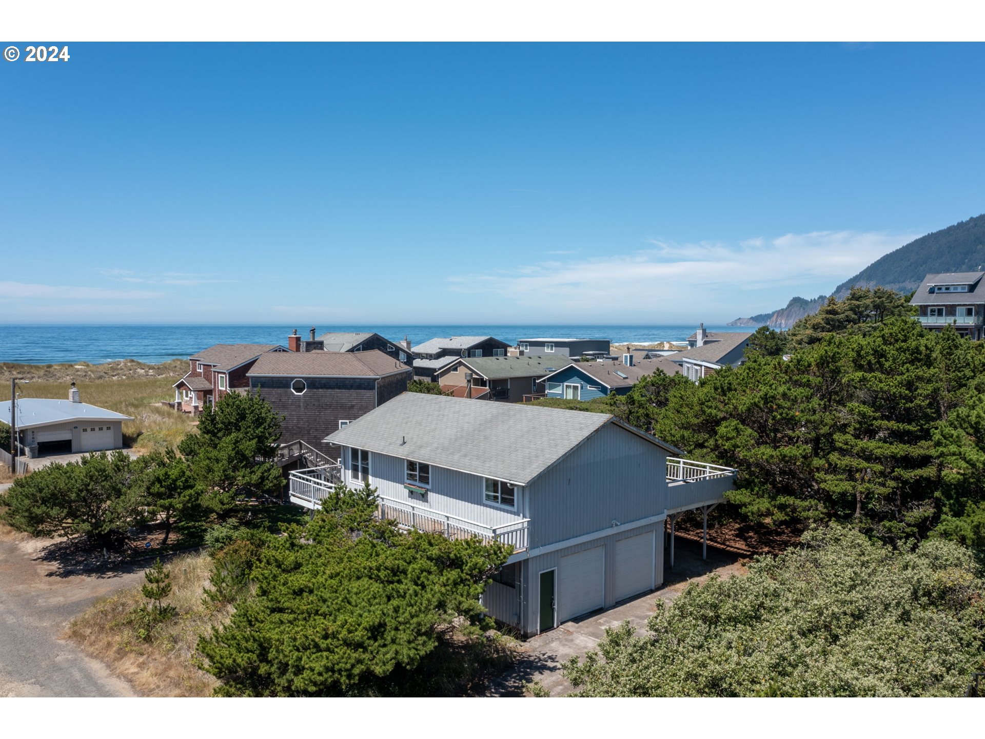 an aerial view of a house with a yard and lake view