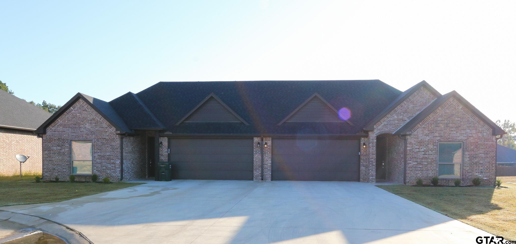 a view of a house with a backyard and a garage