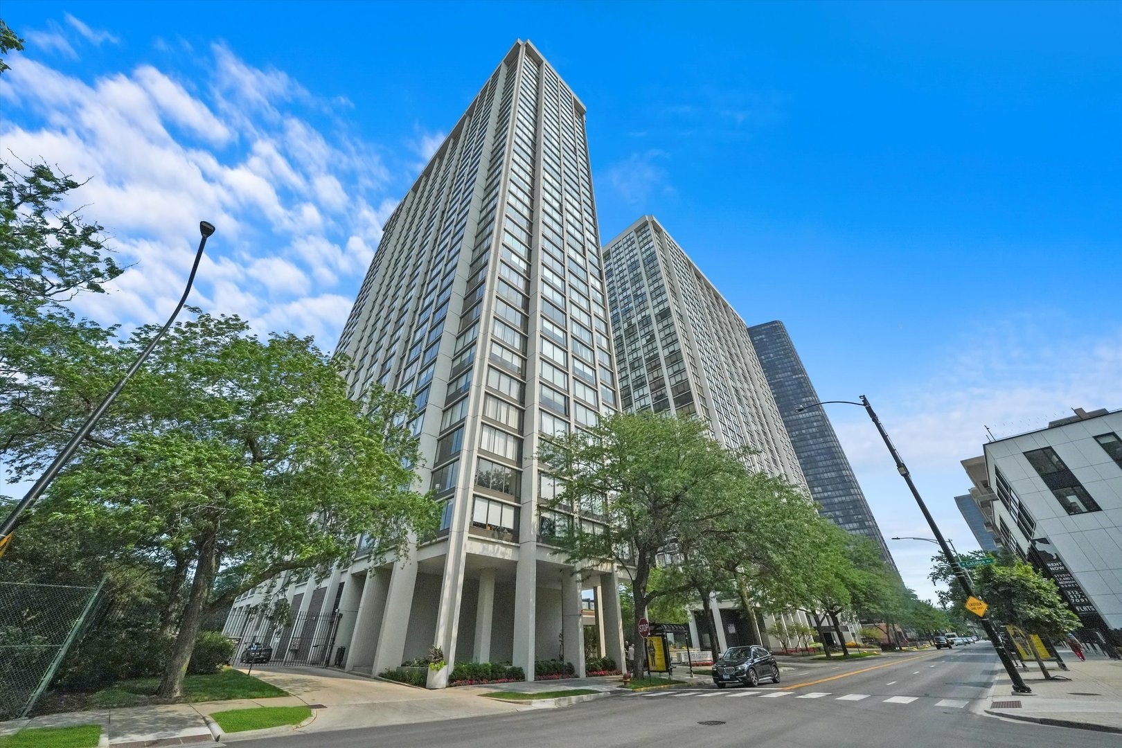 a view of a tall building next to a road